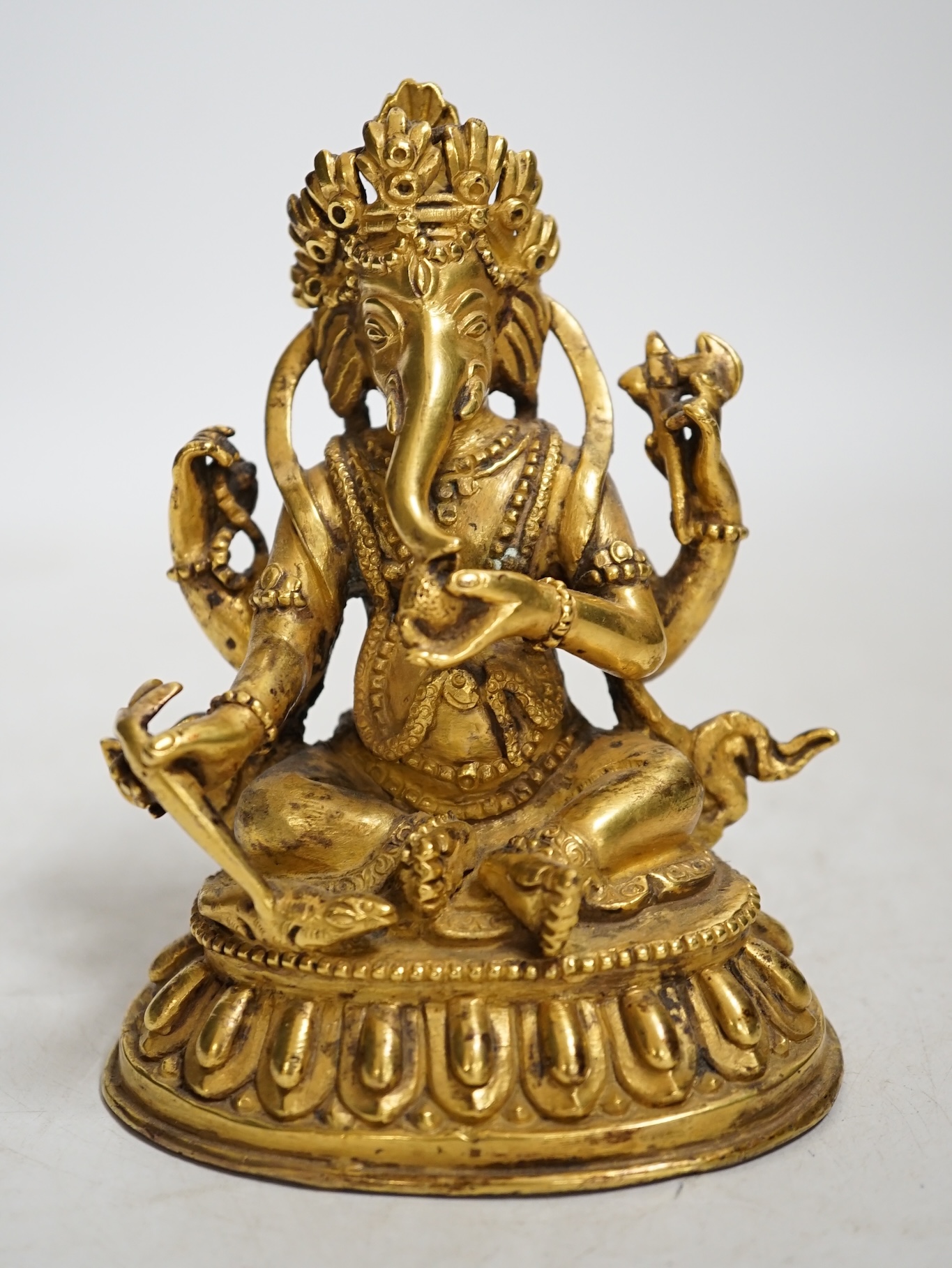A gilt bronze figure of Ganesha, 13cm high. Condition - fair